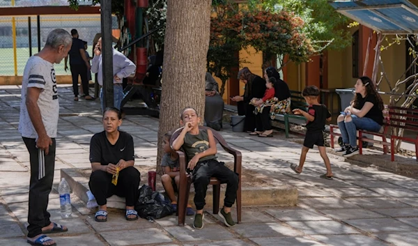 Displaced people sit at a vocational training center run by the UN agency for Palestinian refugees, or UNRWA, in the town of Sebline, south of Beirut, Lebanon, Friday, October 4, 2024 (AP)