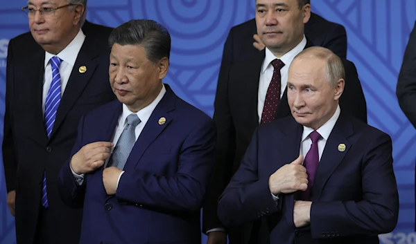 Chinese President Xi Jinping, left, and Russian President Vladimir Putin attend a family photo ceremony prior to Outreach/BRICS Plus format session at the BRICS Summit in Kazan, Russia, on October 24, 2024. (AP)