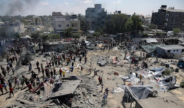 Palestinians inspect the damage at a site hit by an Israeli bombardment on Khan Younis, southern Gaza Strip, July 13, 2024. (AP)