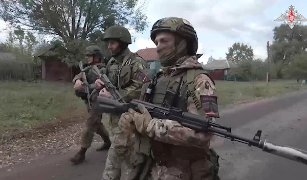 In this photo taken from video released by the Russian Defense Ministry on Thursday, Oct. 24, 2024, Russian soldiers patrol a village in the Russian - Ukrainian border area in the Kursk region, Russia. (AP)