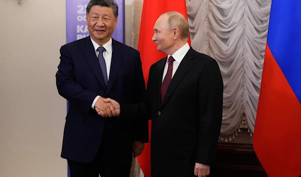 Russian President Vladimir Putin, right, and Chinese President Xi Jinping shake hands during their meeting on the sidelines of BRICS Summit at Kazan Kremlin in Kazan, Russia, Tuesday, Oct. 22, 2024.