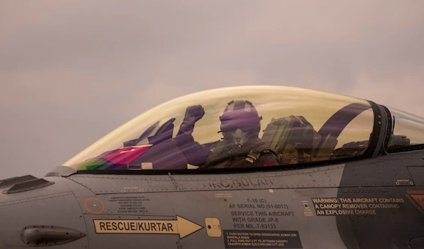 A Turkish Air Force pilot gestures from the cockpit of an F-16 military fighter jet before an Air Policing exercise at the Baza 86 military air base, outside Fetesti, Romania, Wednesday, March 6, 2024 (AP)