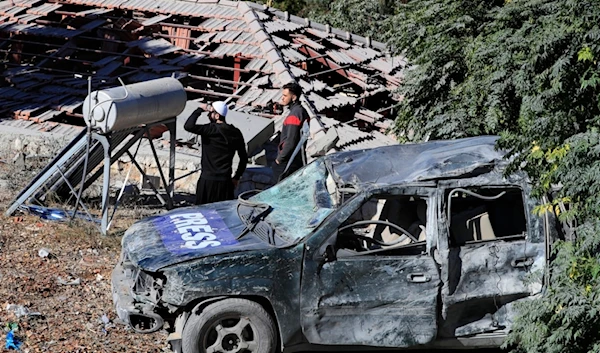 People observe the site where an Israeli airstrike hit a compound housing journalists in Hasbaya village, southeast Lebanon, Friday, October 25, 2024 (AP)