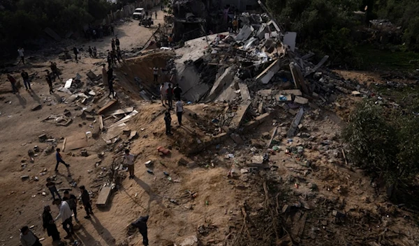 Palestinians inspect the rubble of a house after it was struck by an Israeli airstrike in Beit Lahia, northern Gaza Strip, Friday, May 12, 2023. (AP)