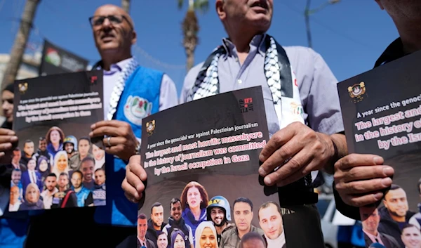 Palestinian journalists hold posters during a protest ahead of the one year anniversary of the war on Gaza, in the West Bank city of Ramallah Sunday, Oct. 6, 2024. (AP)