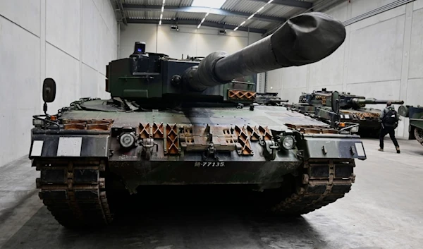 A Leopard 2 tank is seen on the production line as German Chancellor Olaf Scholz and Defense Minister Boris Pistorius visit the future Rheinmetall arms factory site in Unterlüß, Germany. (AP)