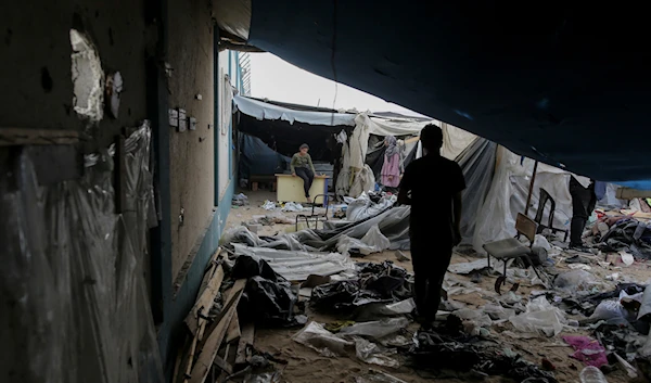 Displaced Palestinians inspect their tents destroyed by Israel's bombardment, adjunct to an UNRWA facility west of Rafah city, Gaza Strip, Tuesday, May 28, 2024.