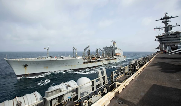 This handout photo from the U.S. Navy shows the Henry J. Kaiser-class fleet replenishment oiler USNS Big Horn sailing alongside the aircraft carrier USS Abraham Lincoln on September 11, 2024, at an undisclosed location at sea in the Middle East (AP)