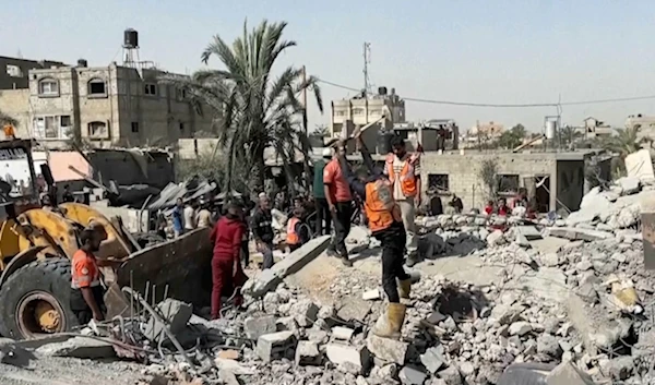 Palestinians check a building destroyed by Israeli airstrikes in the city of Khan Younis, southern Gaza Strip, Friday, Oct. 25, 2024. (AP Photo)