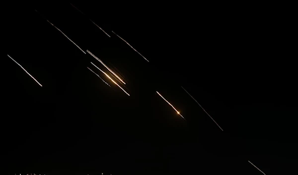 Missiles launched from Iran towards occupied Palestine are seen in the West Bank city of Nablus Tuesday, Oct. 1, 2024. (AP)