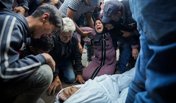 Palestinians mourn their relatives killed in the Israeli bombardment of the Gaza Strip at a hospital morgue in Deir al-Balah, Tuesday, Oct. 29, 2024. (AP)