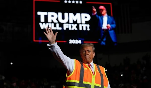 The Republican kept his bright orange safety vest on for his rally in Green Bay, Wisconsin (AP)