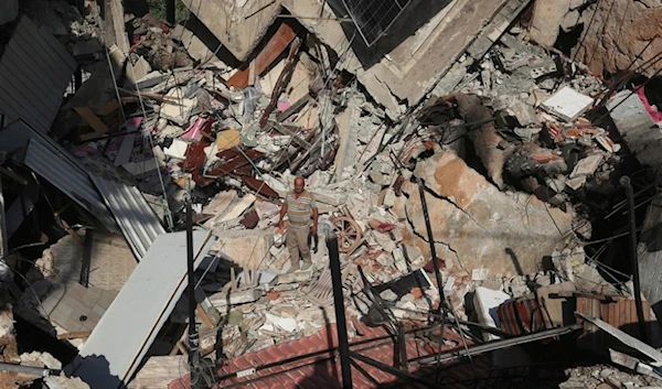 A man stands on the rubble of a building hit in an Israeli airstrike in the southern village of Akbieh, Lebanon, on Tuesday, September 24, 2024. (AP)