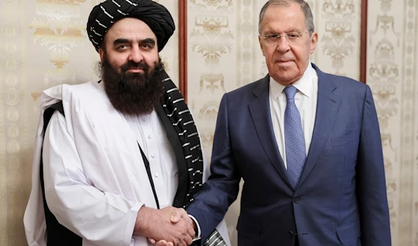 Russian Foreign Minister Sergey Lavrov, right, and Acting Foreign Minister of Afghanistan's Taliban movement Amir Khan Muttaqi pose for a photo prior to their talks in Moscow, Russia, Oct. 4, 2024 (Russian Foreign Ministry Press Service via AP)