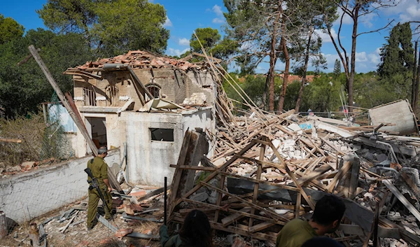 Israeli soldiers look at a destroyed building that was hit in Iran's retaliatory attack in Hod Hasharon, "Israel", October 2, 2024. (AP)