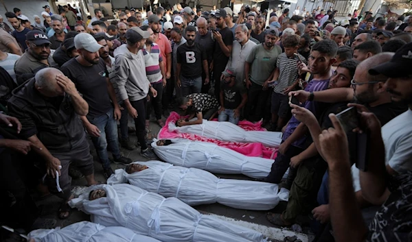 Mourners gather around the bodies of Palestinian men who were killed in an Israeli airstrike in Deir al-Balah, Gaza, Sunday, Oct. 6, 2024. (AP)