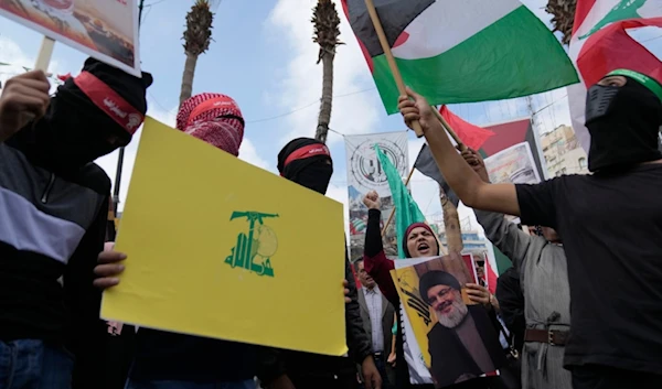 Palestinian activists chant slogans during a protest marking the one year anniversary of Operation Al-Aqsa Flood, in the West Bank city of Ramallah, Monday, Oct. 7, 2024. (AP)