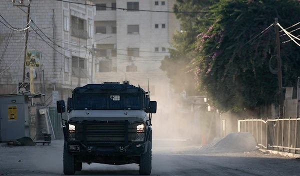 An Israeli armoured vehicle moves on a street during a military operation in the West Bank city of Jenin, on September 25, 2024. (AP)