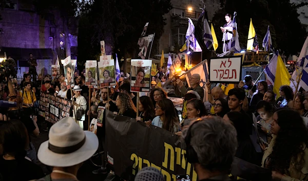 People protest on the one-year anniversary of the Hamas attack on Israel and call for the release of hostages held by Hamas in the Gaza Strip, outside Prime Minister Benjamin Netanyahu's house, in al-Quds on October 7, 2024.