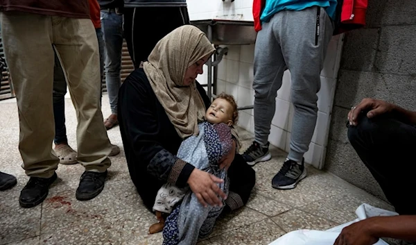 A Palestinian mother mourns her child killed in the Israeli bombardment of the Gaza Strip at a hospital morgue in Deir al-Balah, Wednesday, Oct.2.2024. (AP)