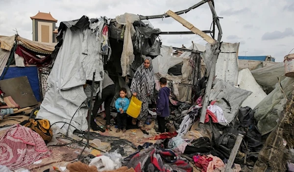 Displaced Palestinians inspect their tents destroyed by Israeli bombardment, adjunct to an UNRWA facility west of Rafah city, Gaza Strip, Tuesday, May 28, 2024. (AP)