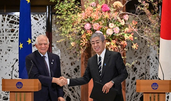 EU foreign policy chief Josep Borrell (L) and Japanese Foreign Minister Takeshi Iwaya (R) shake hands following a signing ceremony at the Iikura Guest House in Tokyo on November 1, 2024.