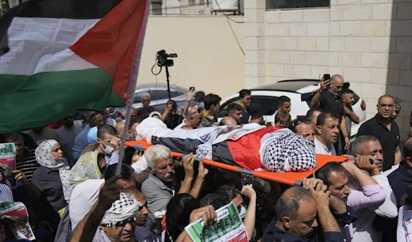 Palestinian mourners carry the body of Aysenur Ezgi Eygi who was fatally shot by Israeli soldiers while participating in an anti-settlement protest in the West Bank during her funeral procession in the West Bank city of Nablus, on September 9, 2024. (AP)