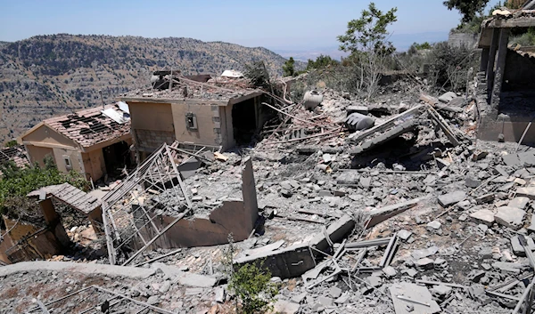 A civil defense worker inspects destroyed houses that were hit by an Israeli airstrike, in Chebaa, a Lebanese town near the border with occupied Palestine, south Lebanon, June 26, 2024. (AP)