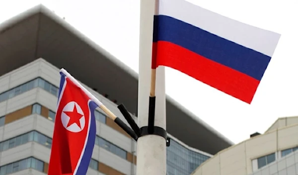 Flags of Russia, right, and North Korea are seen along the road on Russky Island, in Vladivostok, Russia, Tuesday, April 23, 2019.