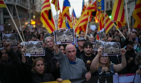 Demonstrators gather for a protest organized by social and civic groups, denouncing the handling of recent flooding under the slogan "Mazón, Resign," in Valencia, Spain, Saturday, Nov. 9, 2024. (AP)