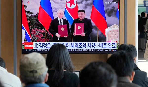 A TV screen shows a file image of North Korean leader Kim Jong Un, right, and Russian President Vladimir Putin in Pyongyang, during a news program at the Seoul Railway Station in Seoul, South Korea, on November 12, 2024. (AP)