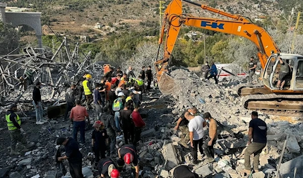 Rescuers use an excavator to search for survivors at the site of an Israeli airstrike that targeted the village of Almat north of Beirut on November 10, 2024 ( AFP)