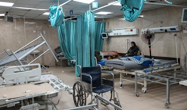 FILE - A woman sits on a bed in a room of the Al-Aqsa Martyrs hospital in Deir al Balah, Gaza Strip, Aug. 25, 2024. (AP Photo/Abdel Kareem Hana, File)