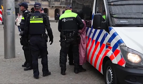 Police detain a person next to the place where Maccabi Tel Aviv supporters gather ahead of the Europa League soccer match between their team and Ajax, in Amsterdam, the Netherlands, Thursday, Nov. 7, 2024. (AP)