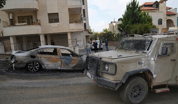 Israeli army investigators arrive at the site of the early morning attack of Israeli settlers, that left at least 18 burnt vehicles, on the outskirts of the West Bank city of al-Bireh on November 4, 2024. (AP)