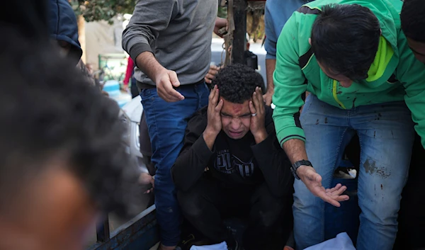 Palestinians mourn their relatives killed in the Israeli bombardment of Maghazi in the Gaza Strip, during their funeral at a hospital morgue in Deir al-Balah, Gaza, on November 14, 2024. (AP)