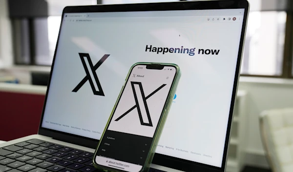 The opening page of X is displayed on a computer and phone, on October 16, 2023, in Sydney. (AP)