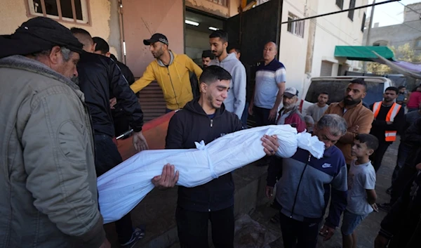 Palestinians mourn nine people killed in an Israeli strike in Bureij refugee camp, Gaza Strip, Friday, November 15, 2024 (AP)