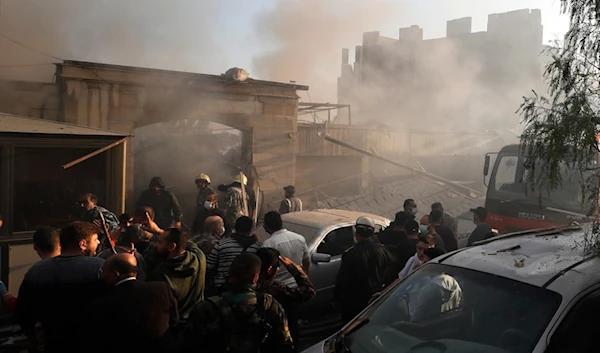 Security officers and rescuers gather at a destroyed building hit in an Israeli airstrike in Damascus, Syria, Thursday, Nov. 14, 2024. (AP)