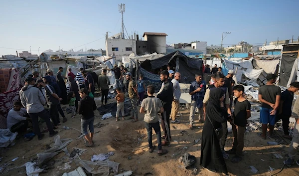 Palestinians gather at the site of an Israeli strike in the courtyard of the Al-Aqsa Hospital where displaced people live in tents, in Deir al-Balah, Gaza Strip, Saturday, Nov. 9, 2024. (AP)