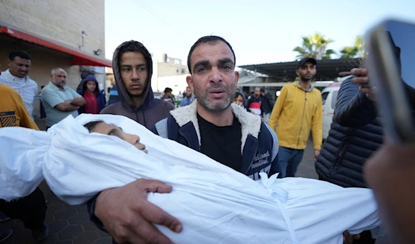 A Palestinian mourns a child, one of of nine people killed in an Israeli strike in Bureij refugee camp, Gaza Strip, Friday, Nov. 15, 2024. (AP)