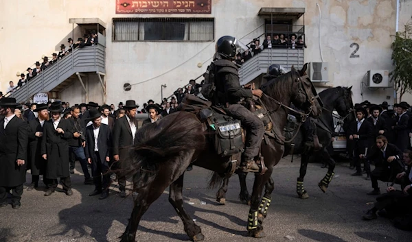 Israeli police officers scuffle with ultra-Orthodox Jewish men during a protest against a potential new draft law in occupied al-Quds, Thursday, Oct. 31, 2024. (AP Photo/Ohad Zwigenberg)