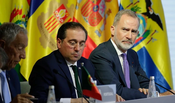 Spain's King Felipe VI, right, and Spanish Foreign Affairs Minister José Manuel Albares, attend at the 29th Ibero-American Summit in Cuenca, Ecuador, Friday, Nov. 15, 2024. (AP)