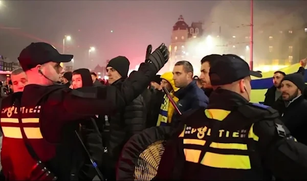 Police escort Maccabi Tel Aviv supporters to the metro station leading the Ajax stadium, after pro- Palestinian supporters marched near the stadium in Amsterdam, Netherlands, November 7, 2024. (AP)