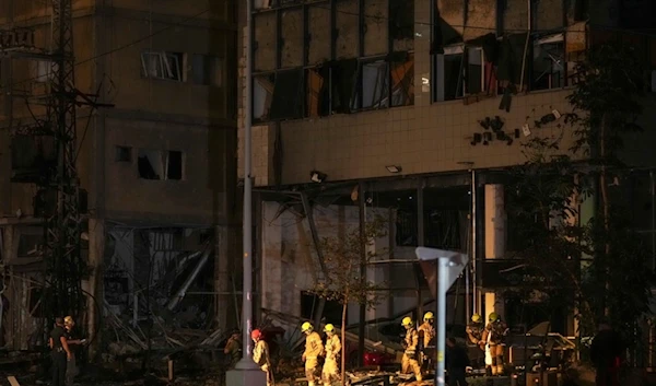 Firemen exit a building damaged by a rocket attack in Ramat Gan, Tel Aviv district, Monday Nov. 18, 2024. (AP)