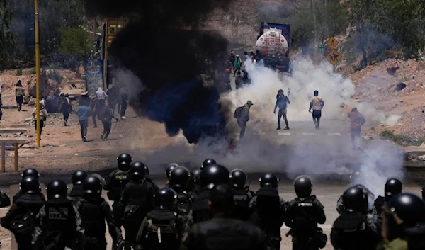 Police launch tear gas to disperse supporters of former President Evo Morales who have been blocking roads for days to prevent him from facing a criminal investigation, Bolivia, Friday, Nov. 1, 2024. (AP)