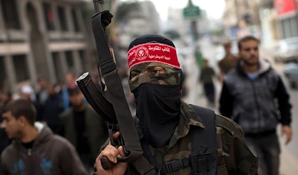 A National Resistance Brigades fighter from the Democratic Front for the Liberation of Palestine (DFLP) attends the funeral procession in, Gaza City, the Gaza Strip, on November 22, 2012 (AP)