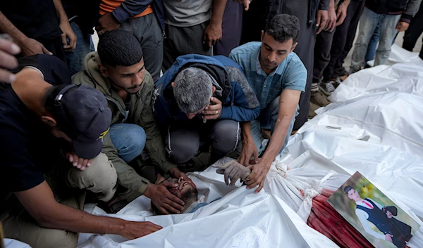 Palestinians mourn their relatives killed in the Israeli bombardment of the Gaza Strip at a hospital morgue in Deir al-Balah, on November 1, 2024. (AP)