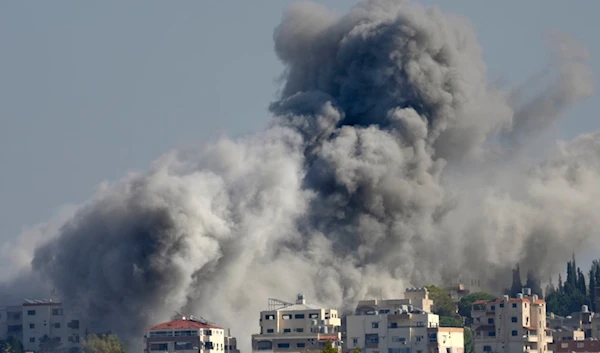 Smoke rises between buildings hit in an Israeli airstrike in Burj al-Shamali village, as seen from Tyre city, south Lebanon, Friday, Nov. 22, 2024. (AP)