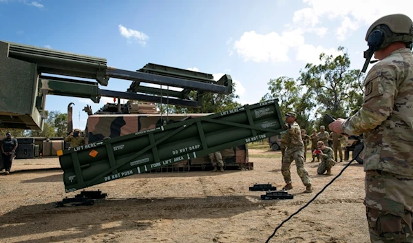 A US Army Staff Sargent adjusts the Army Tactical Missile System (ATACMS) for loading on to the High Mobility Artillery Rocket System (HIMARS) at Williamson Airfield in Queensland, Australia, on July 26, 2023  (AP)